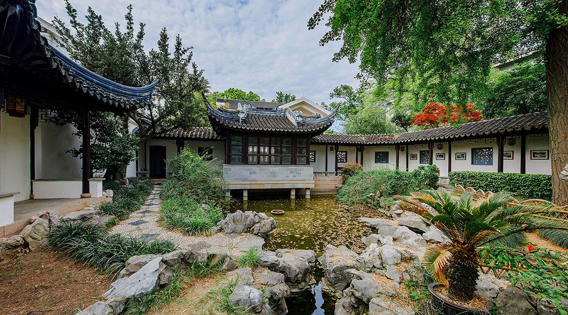 a building with a pond and trees
