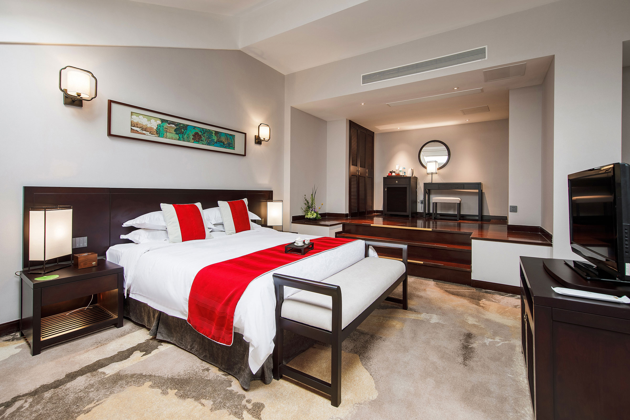 a bedroom with a bed and a mirror