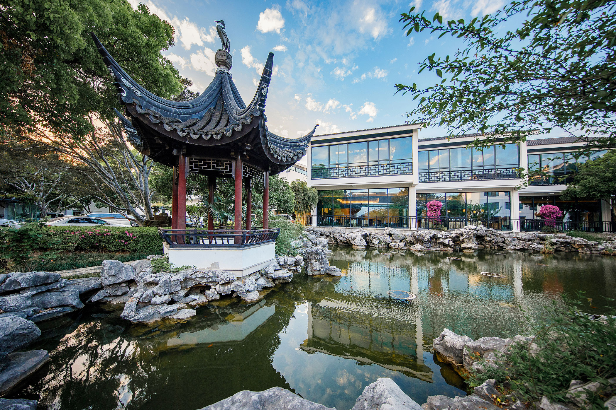 a building with a pond and a gazebo