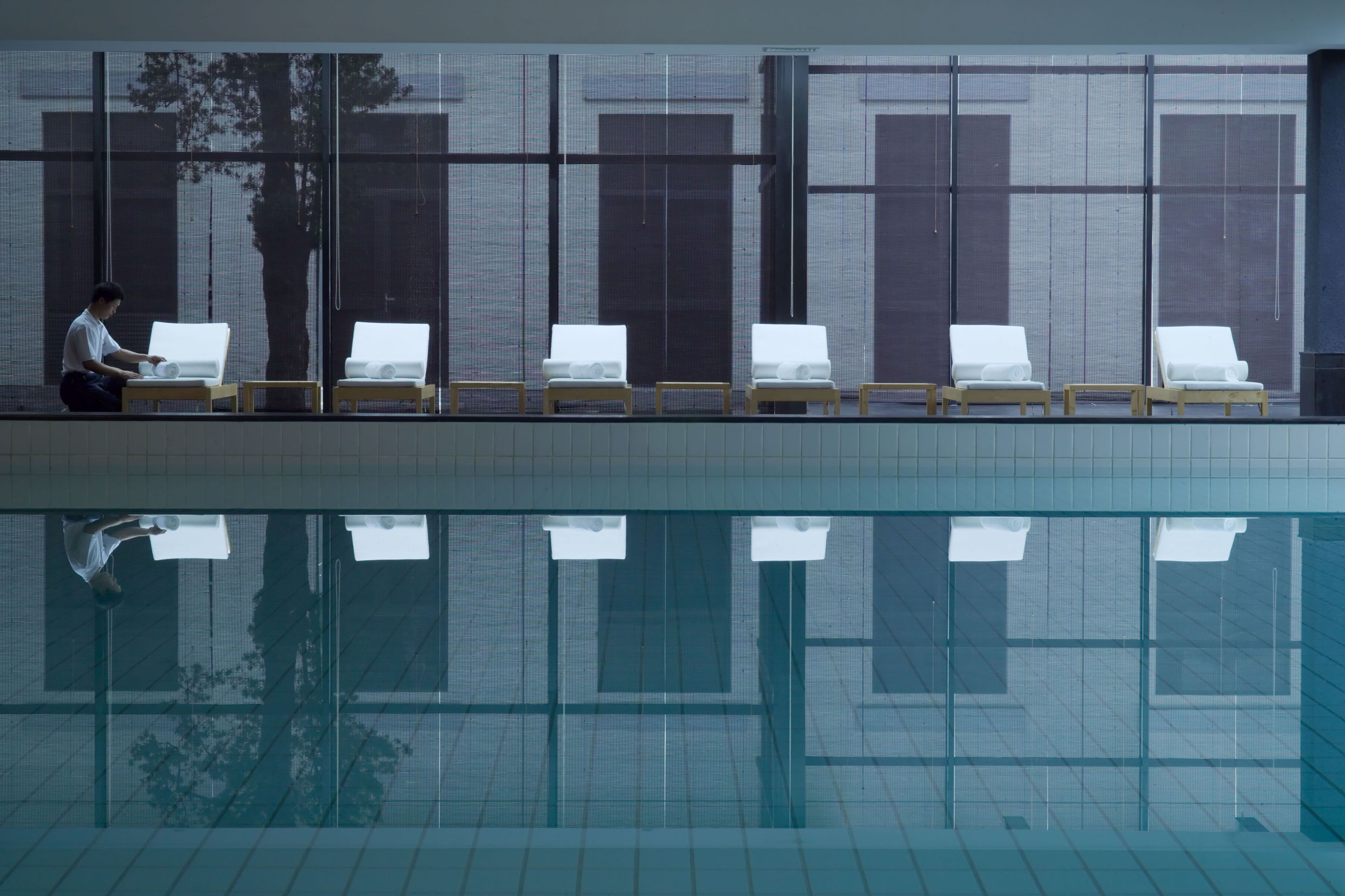 a row of chairs next to a pool