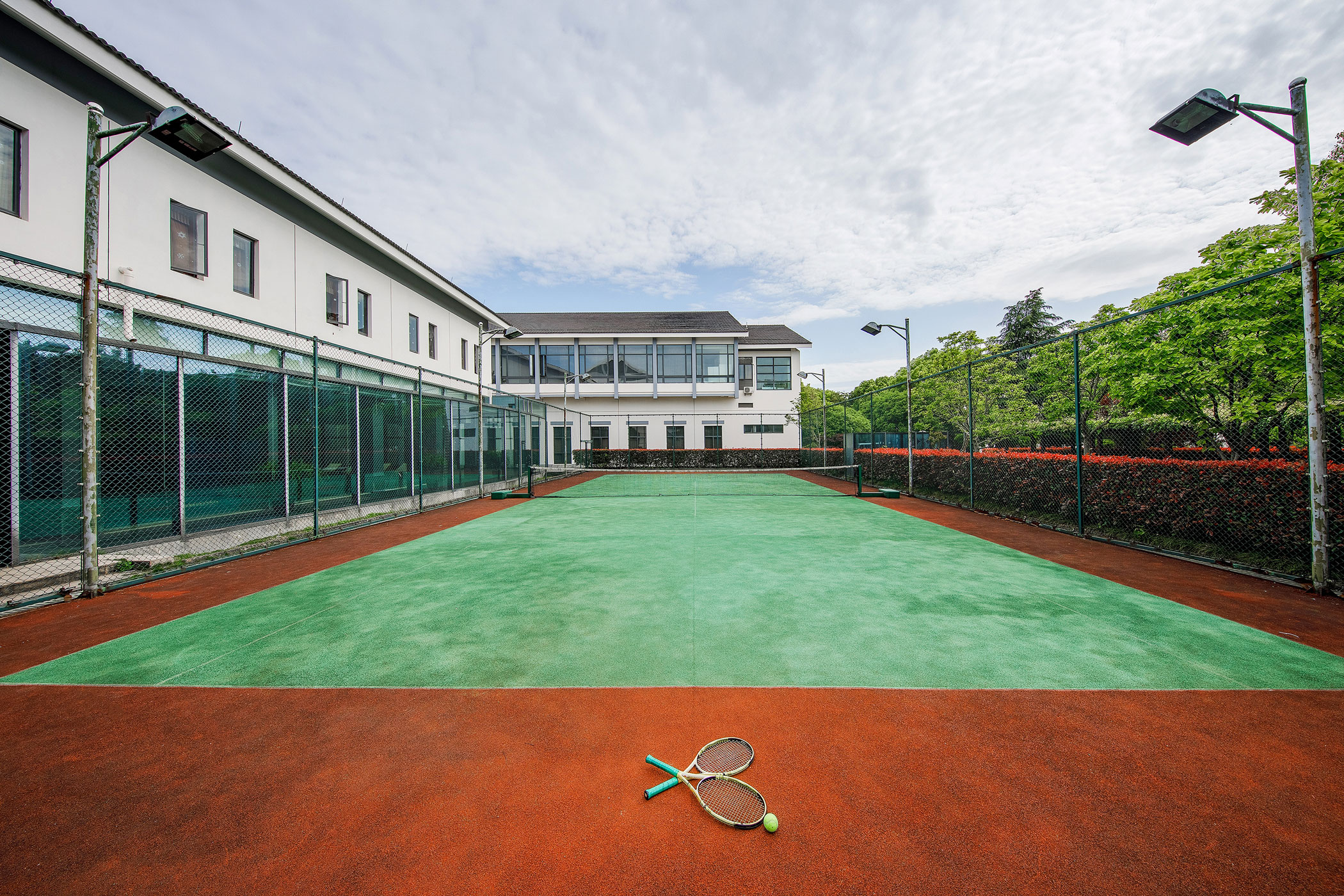 a tennis court with a couple of rackets on the ground