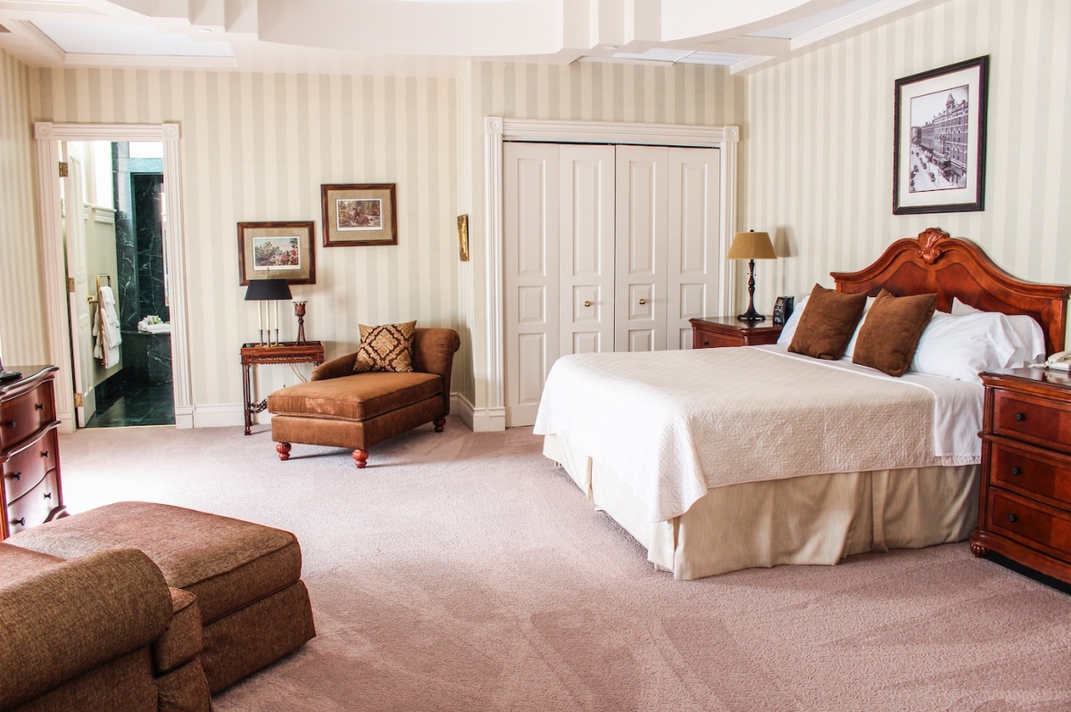 a bedroom with a bed and a chair