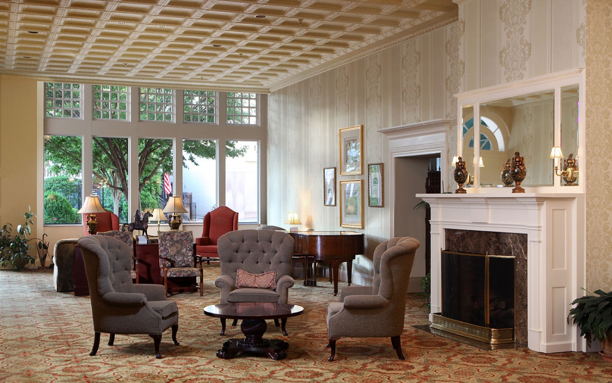 a room with a fireplace and chairs