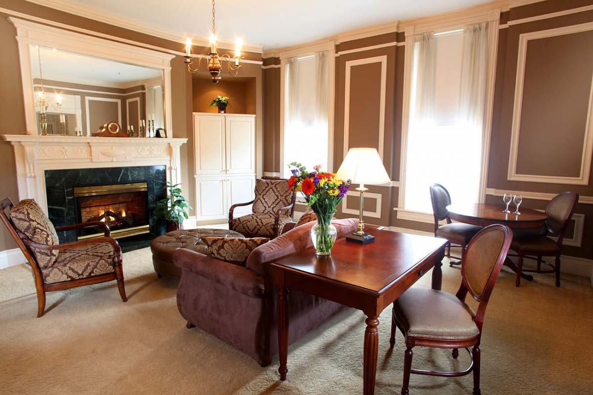 a living room with a fireplace and a table