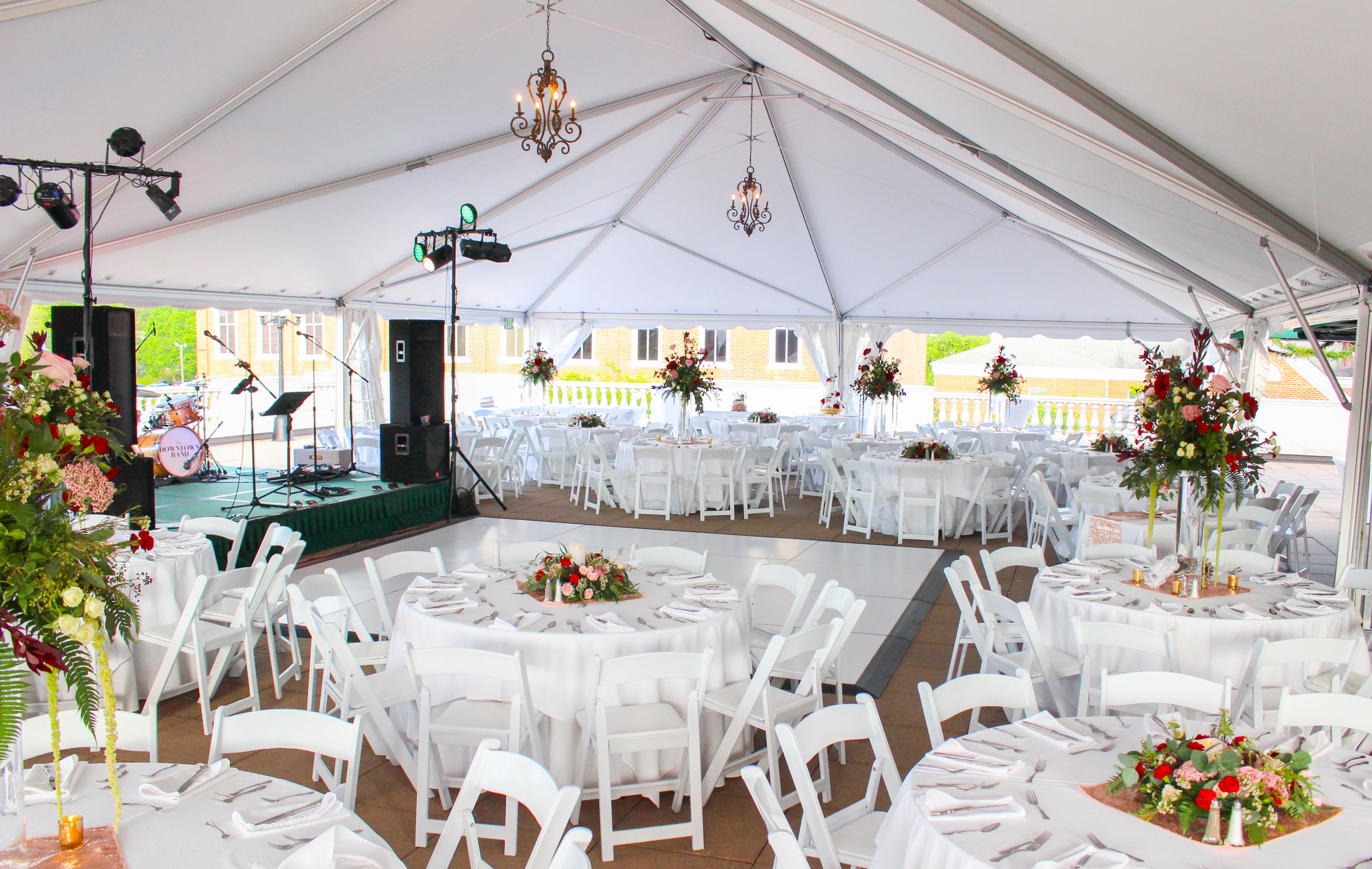 a large white tent with tables and chairs