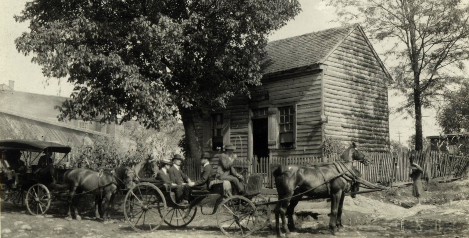 a horse drawn carriage with people in it