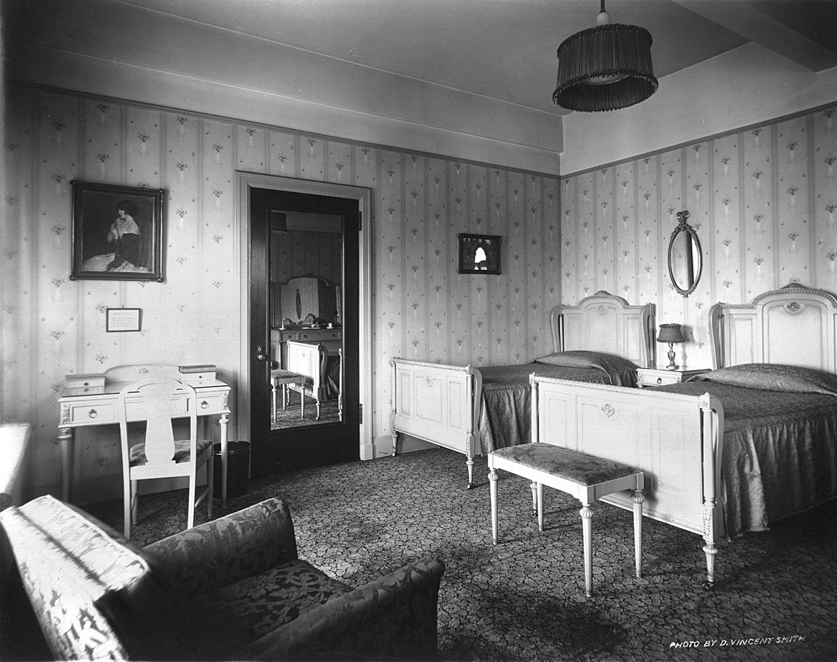 a room with two beds and a mirror