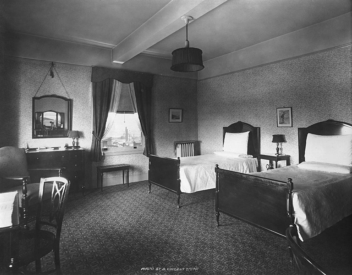 a room with two beds and a mirror