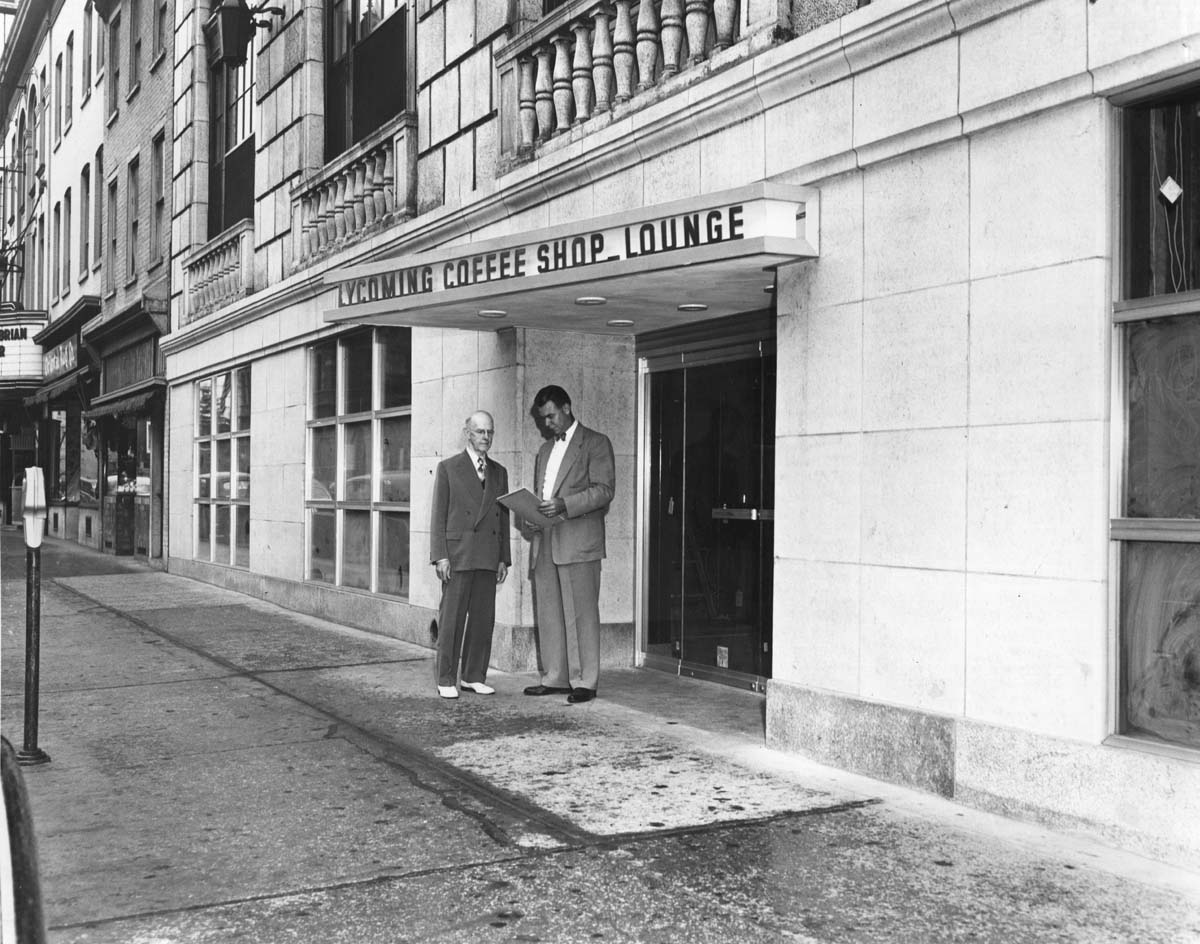 a man standing in front of a building