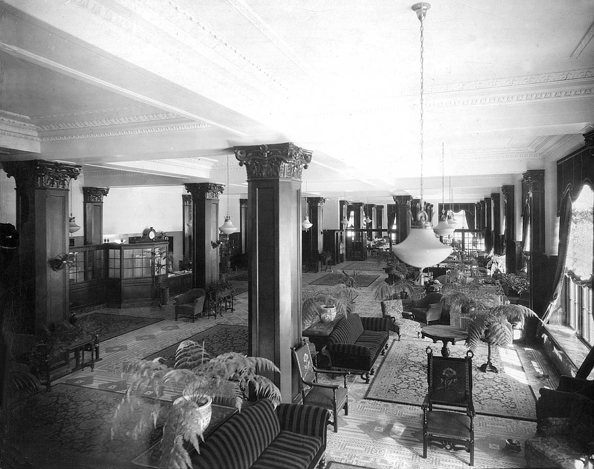 a large room with a large chandelier and chairs
