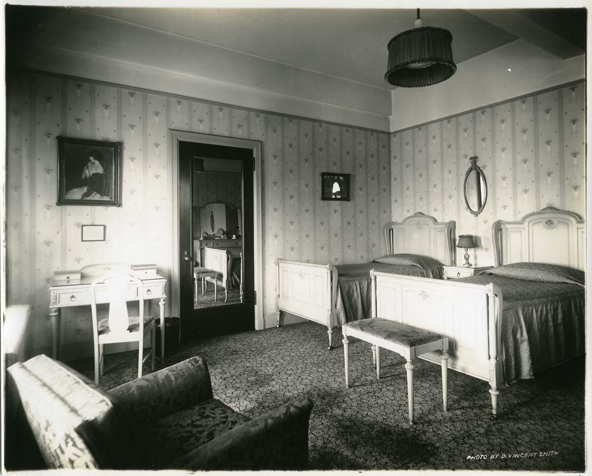 a room with two beds and a mirror