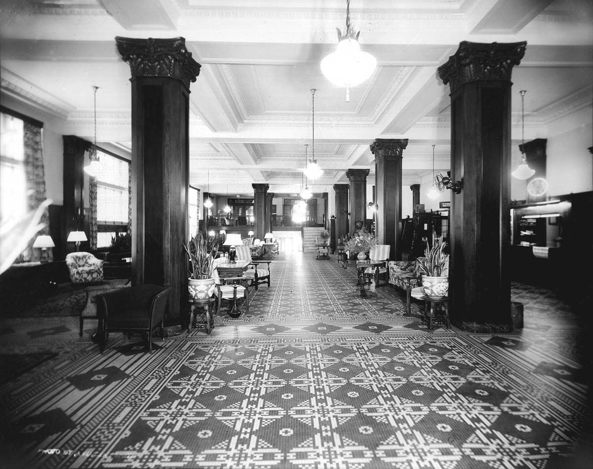 a large hall with columns and chairs