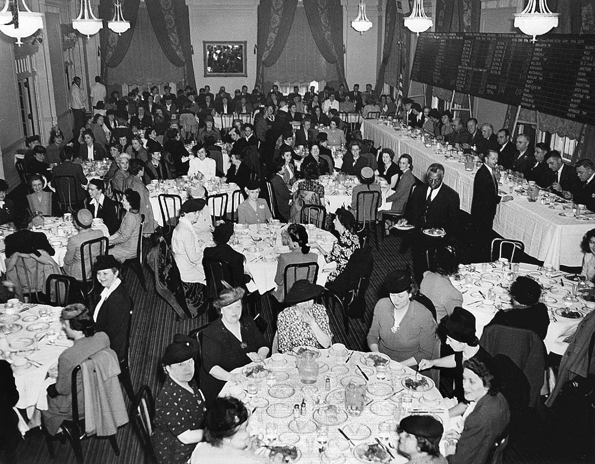 a group of people sitting at tables