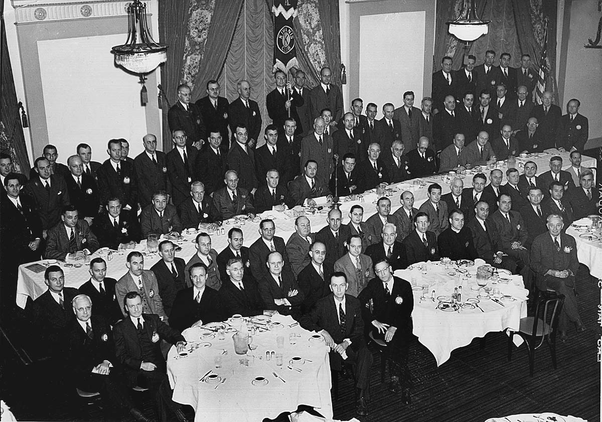 a group of men sitting at tables