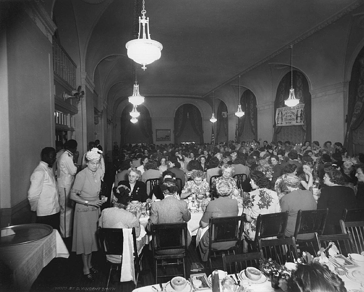 a group of people sitting at tables in a room