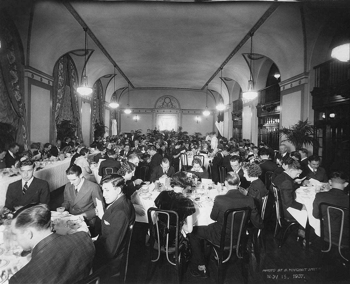 a group of people sitting at tables in a room