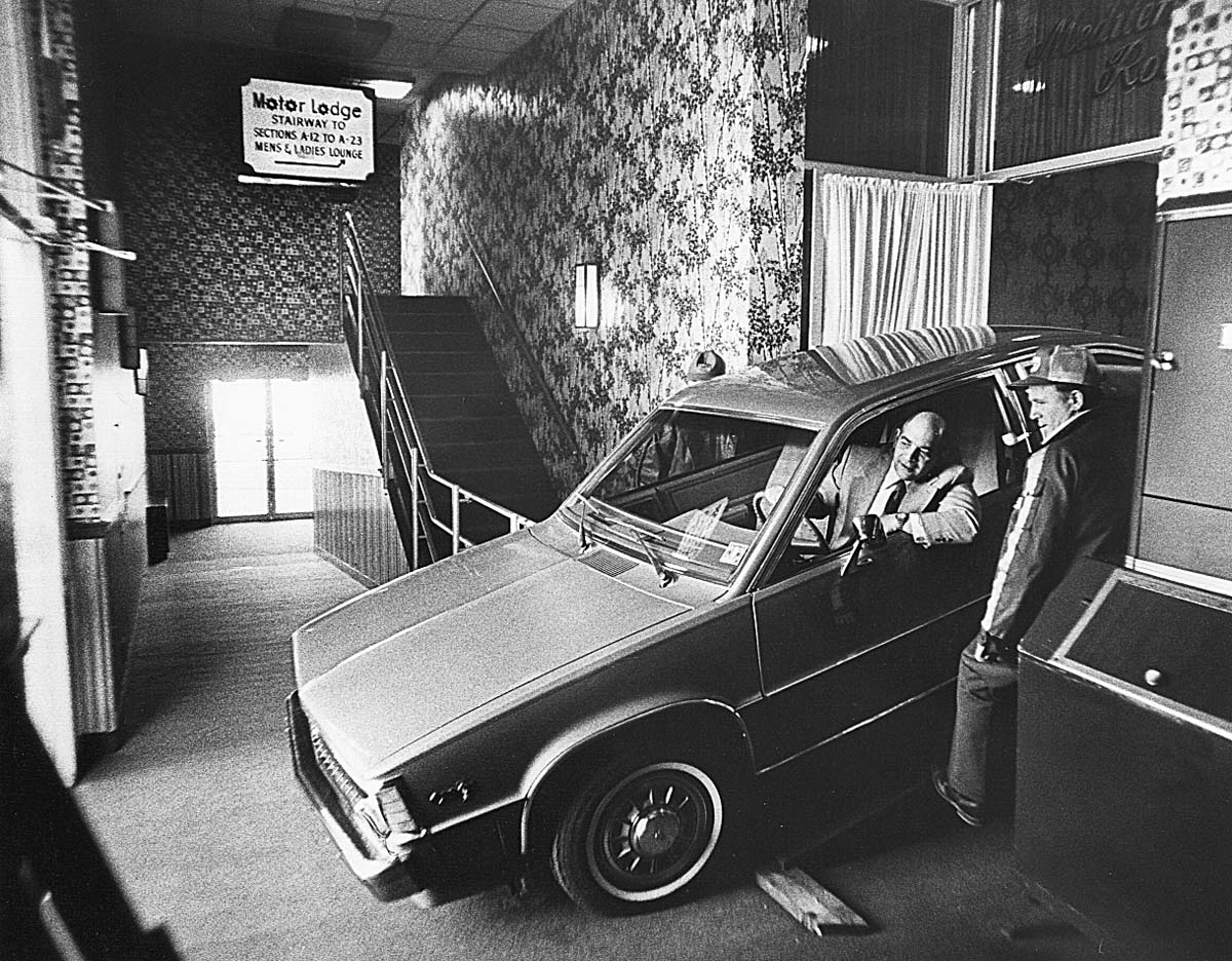 a man standing in a car