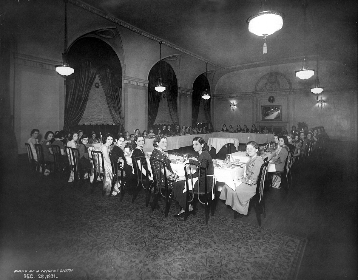 a group of people sitting at tables in a room