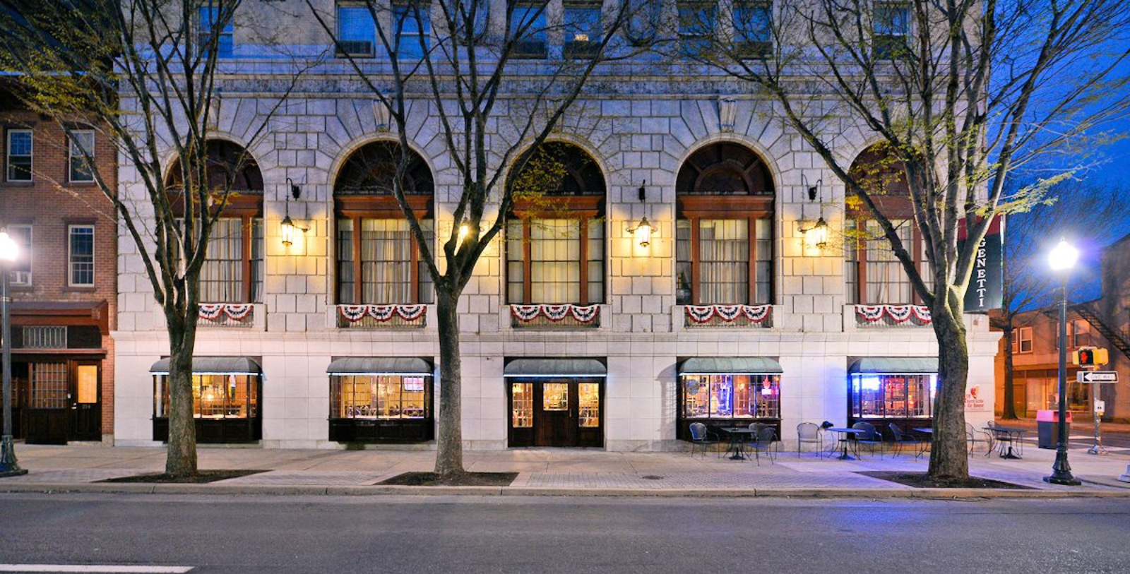 a building with many windows and tables on the side