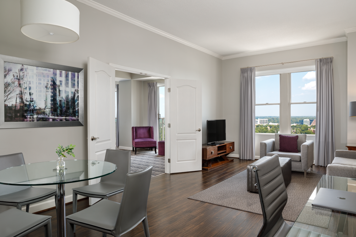 a living room with a table and chairs