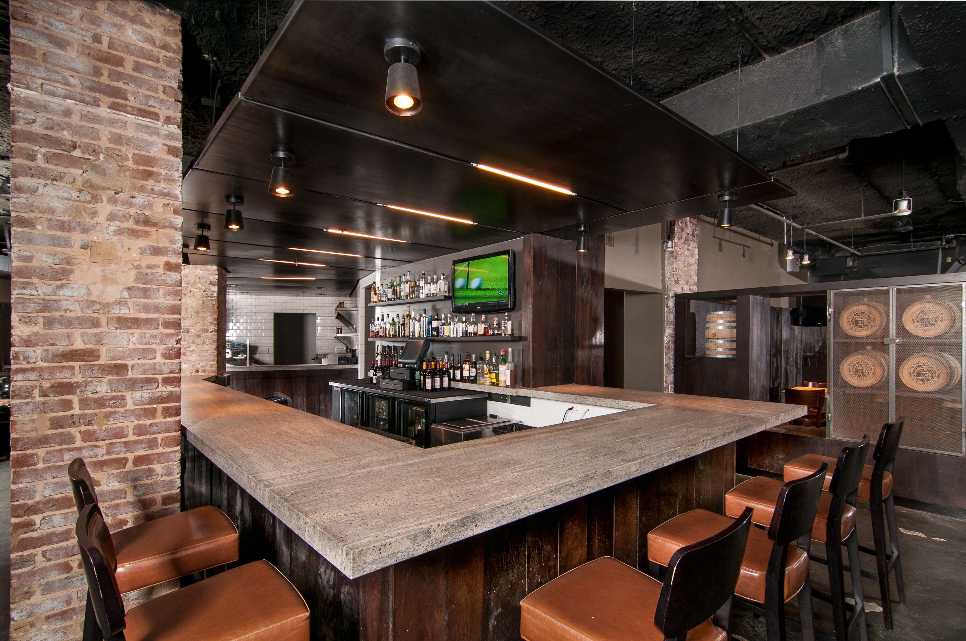a bar with a counter and chairs