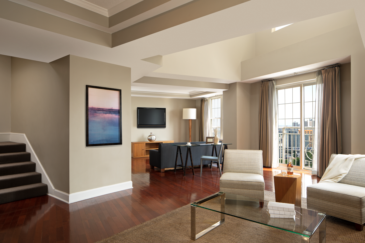 a living room with a glass table and a couch