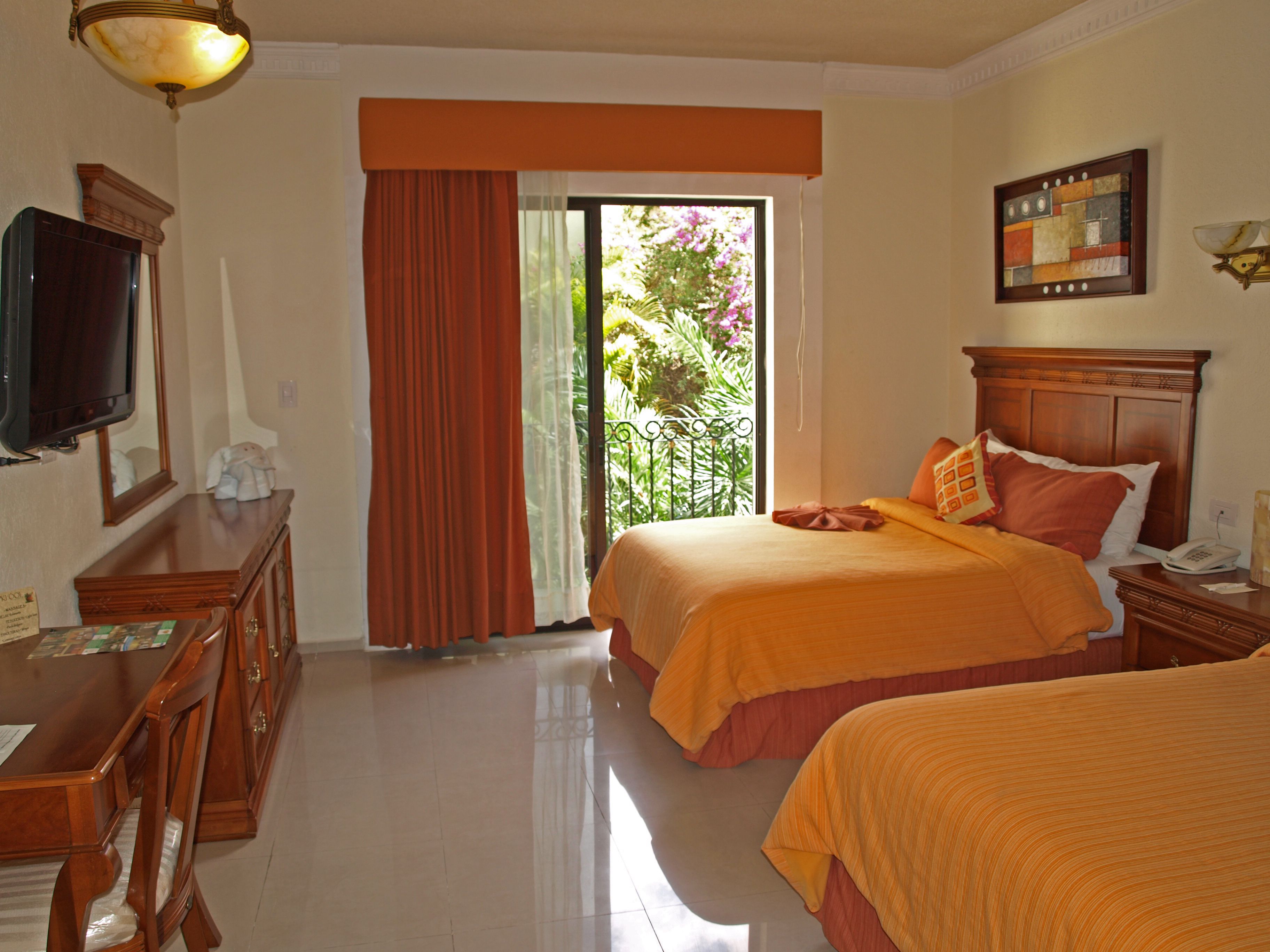 a room with two beds and a window