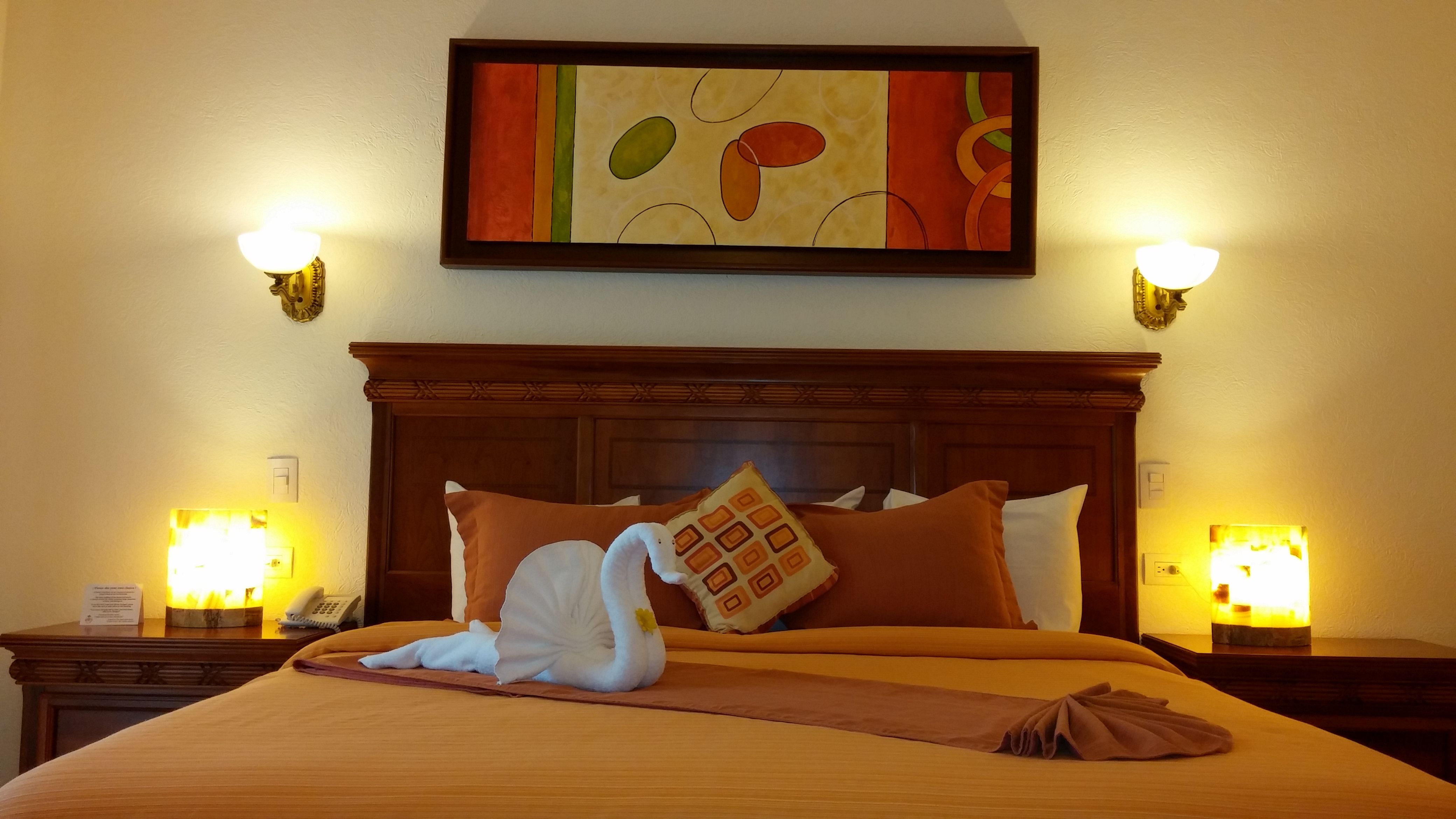 a bed with a swan sculpture