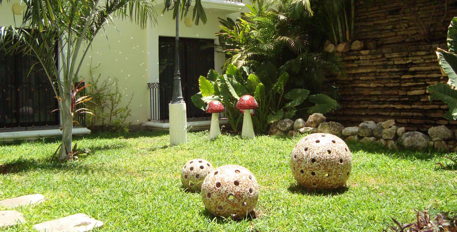 a lawn with decorative balls and mushrooms