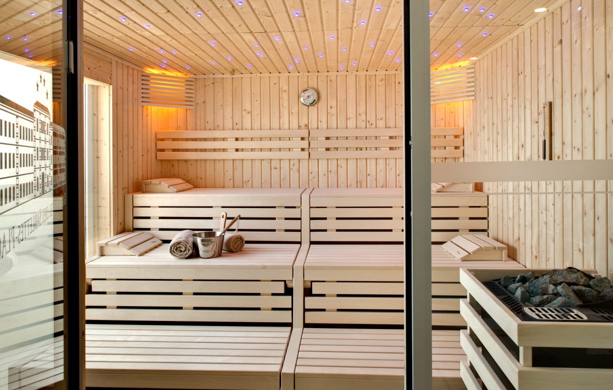 a sauna with a glass door