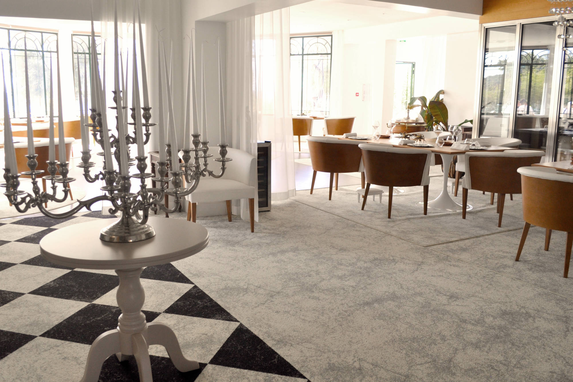 a room with a table and chairs and a candelabra