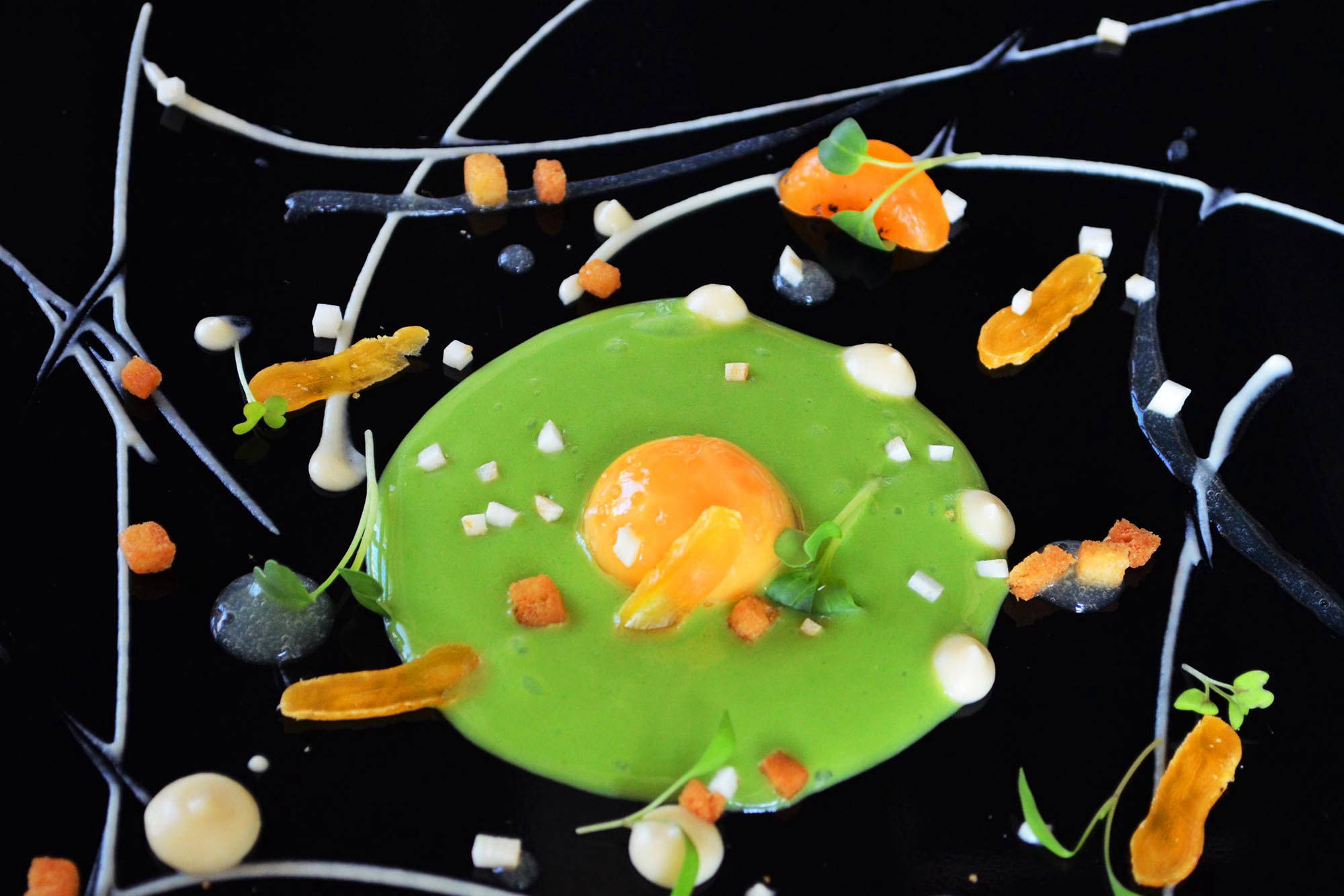 a plate of food with a yolk and some small pieces of food