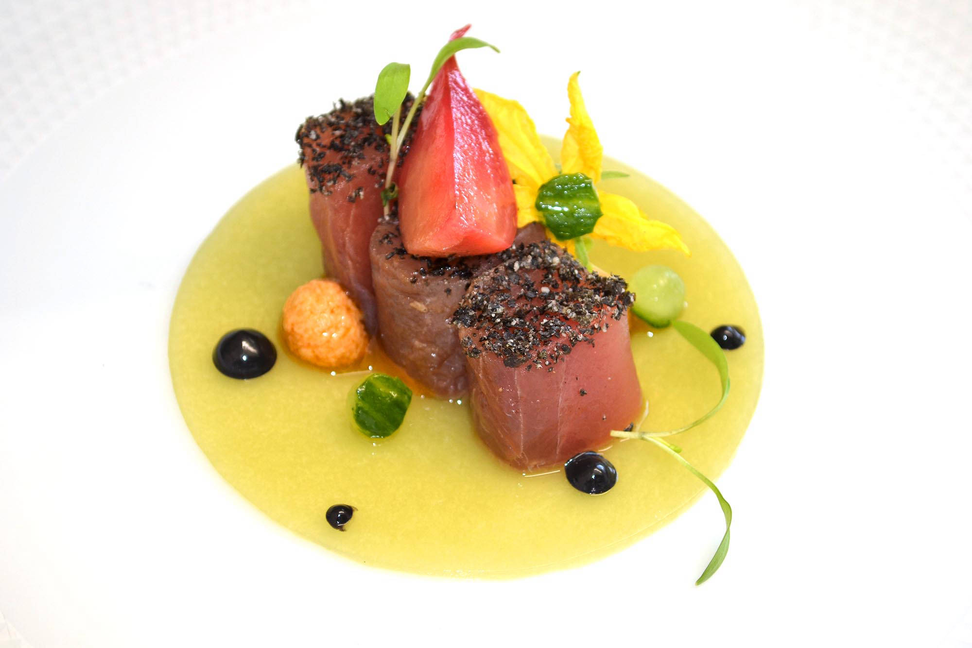 a plate of food with fruit and sauce