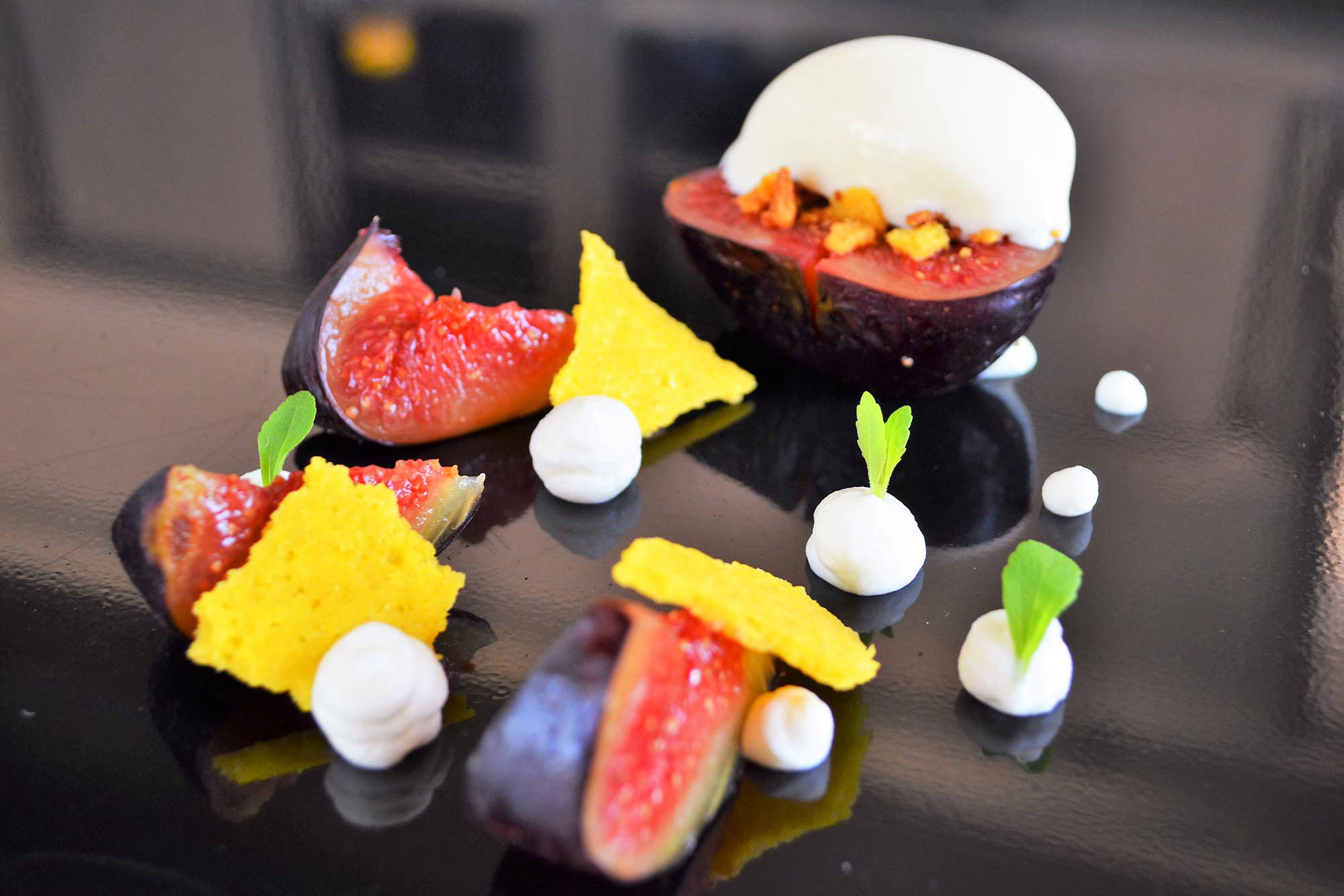 a plate of food on a black surface