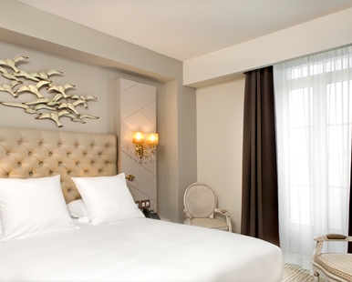 a bedroom with a bed and a chair