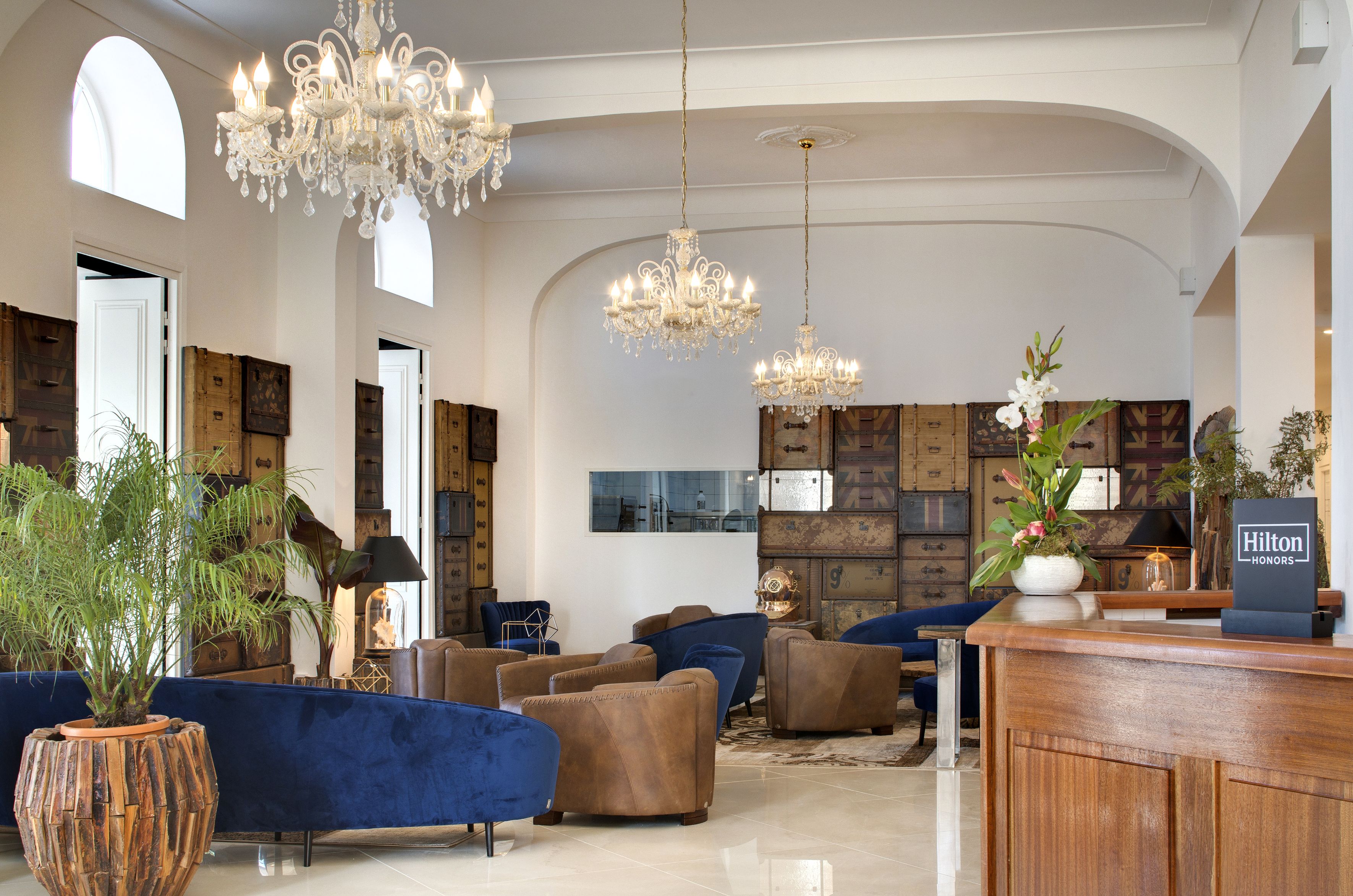 a room with a chandelier and couches