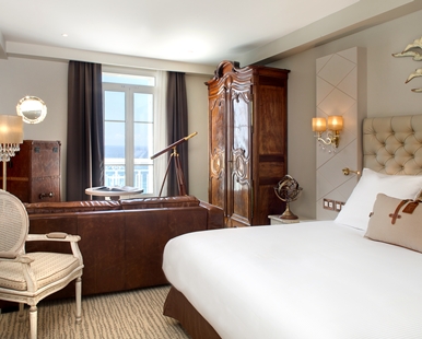a bedroom with a large bed and a large cabinet