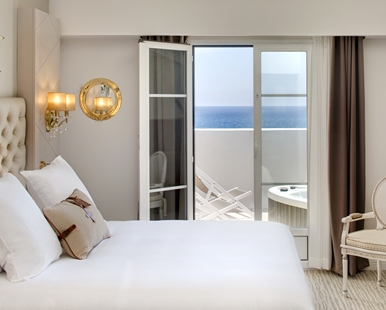 a bedroom with a view of the ocean