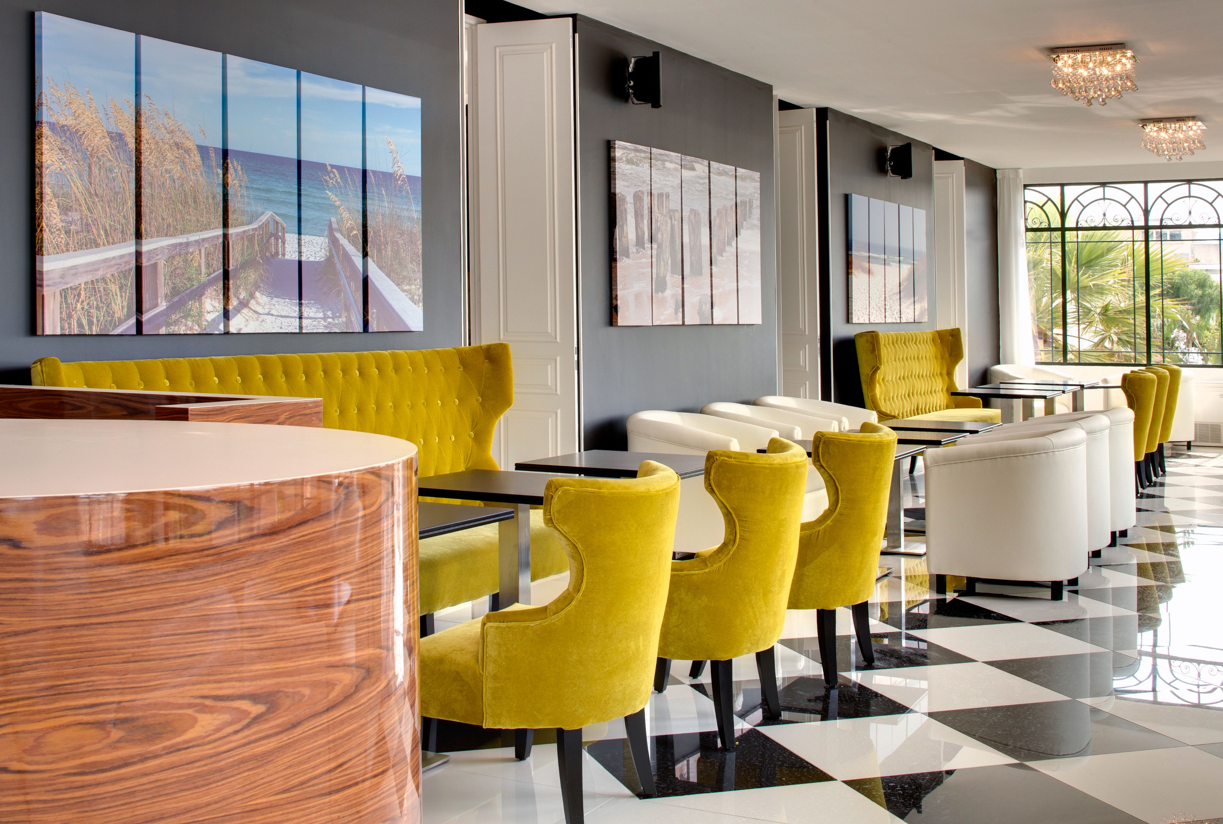 a room with yellow chairs and a black and white checkered floor