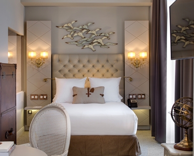 a hotel room with a bed and a television