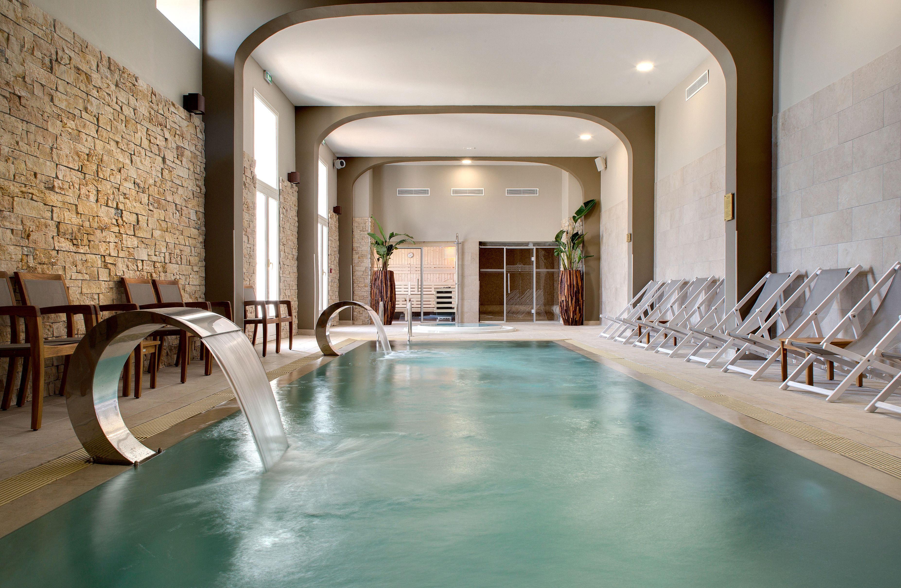 a indoor pool with a waterfall