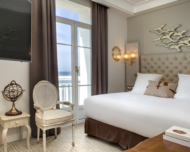 a bedroom with a large bed and a television