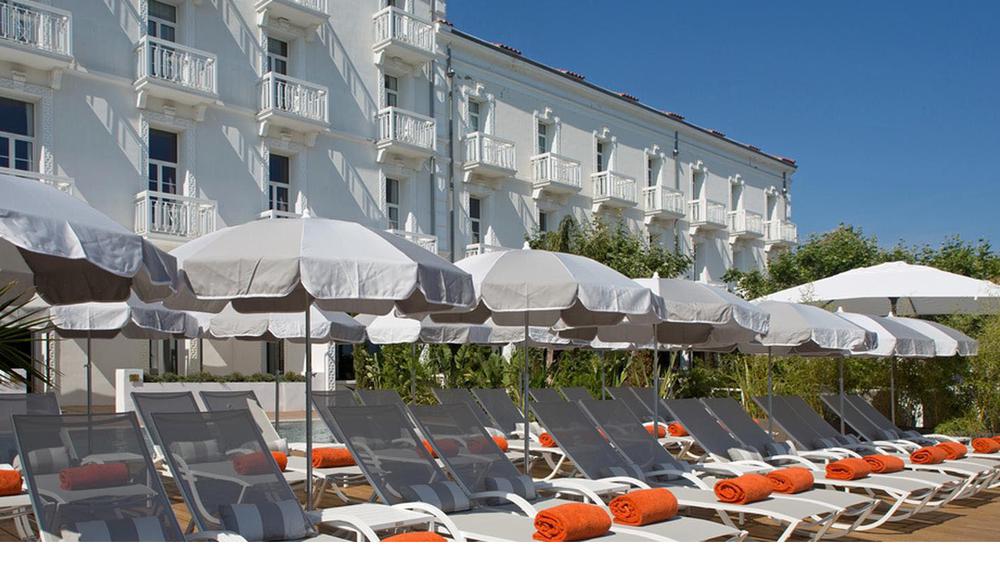 a group of lounge chairs and umbrellas
