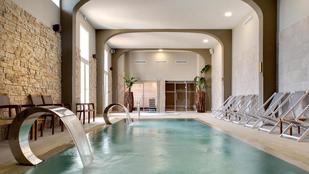 a pool with a waterfall