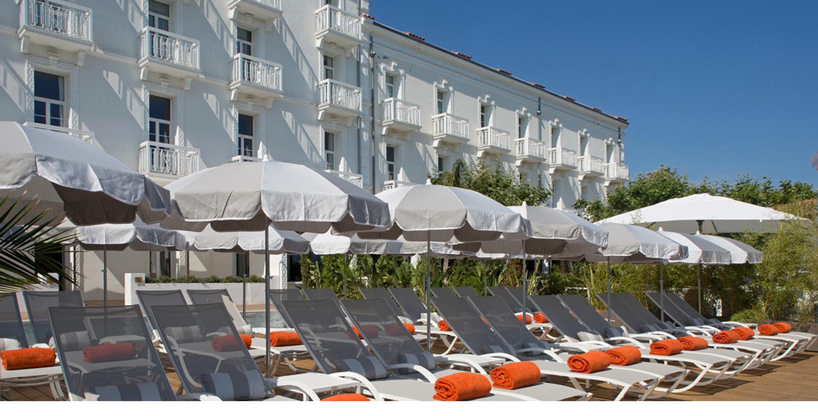 a group of lounge chairs and umbrellas