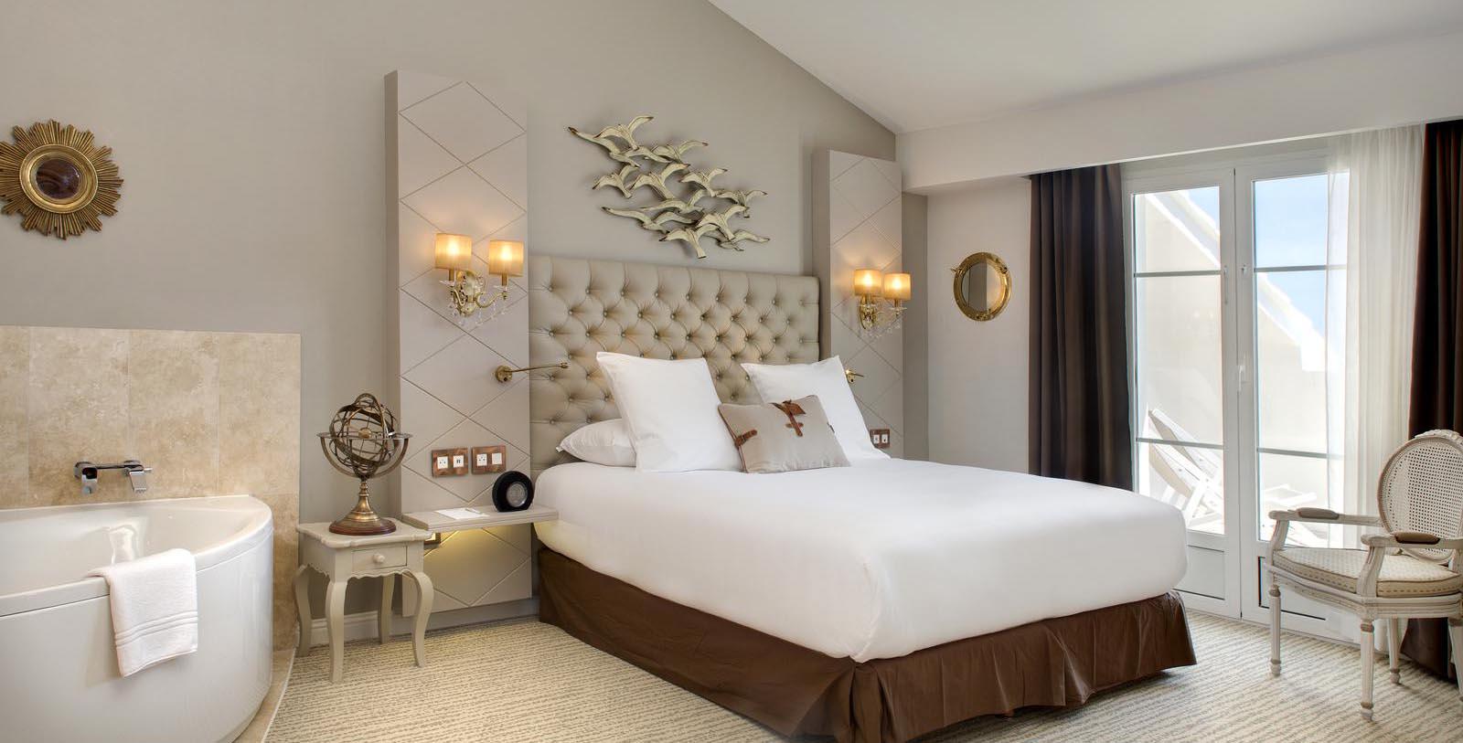 a bed with a white bedding and a brown headboard