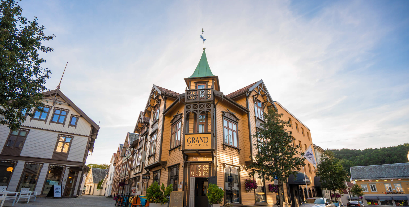 a building with a steeple and a weather vane on the top