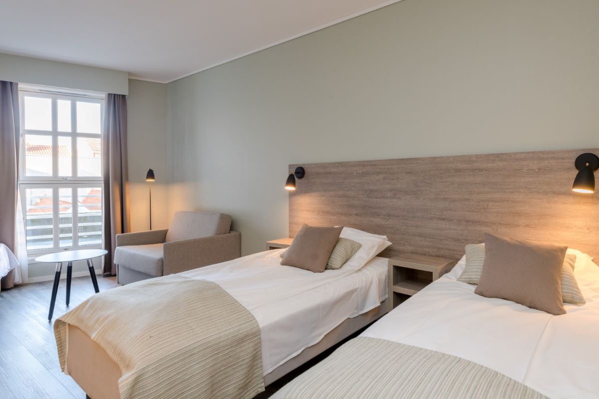 a room with two beds and a couch