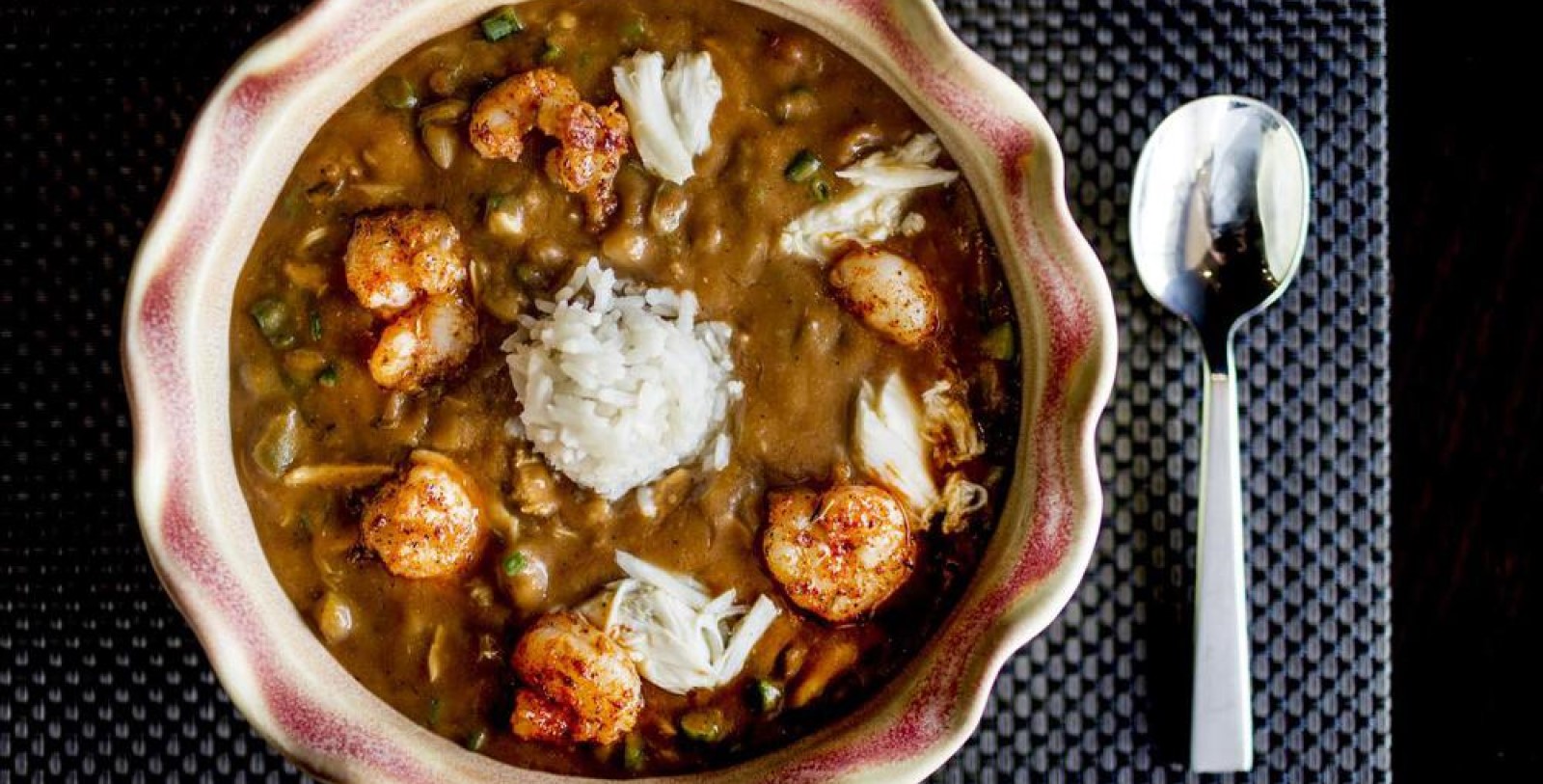 a bowl of food with shrimp and rice