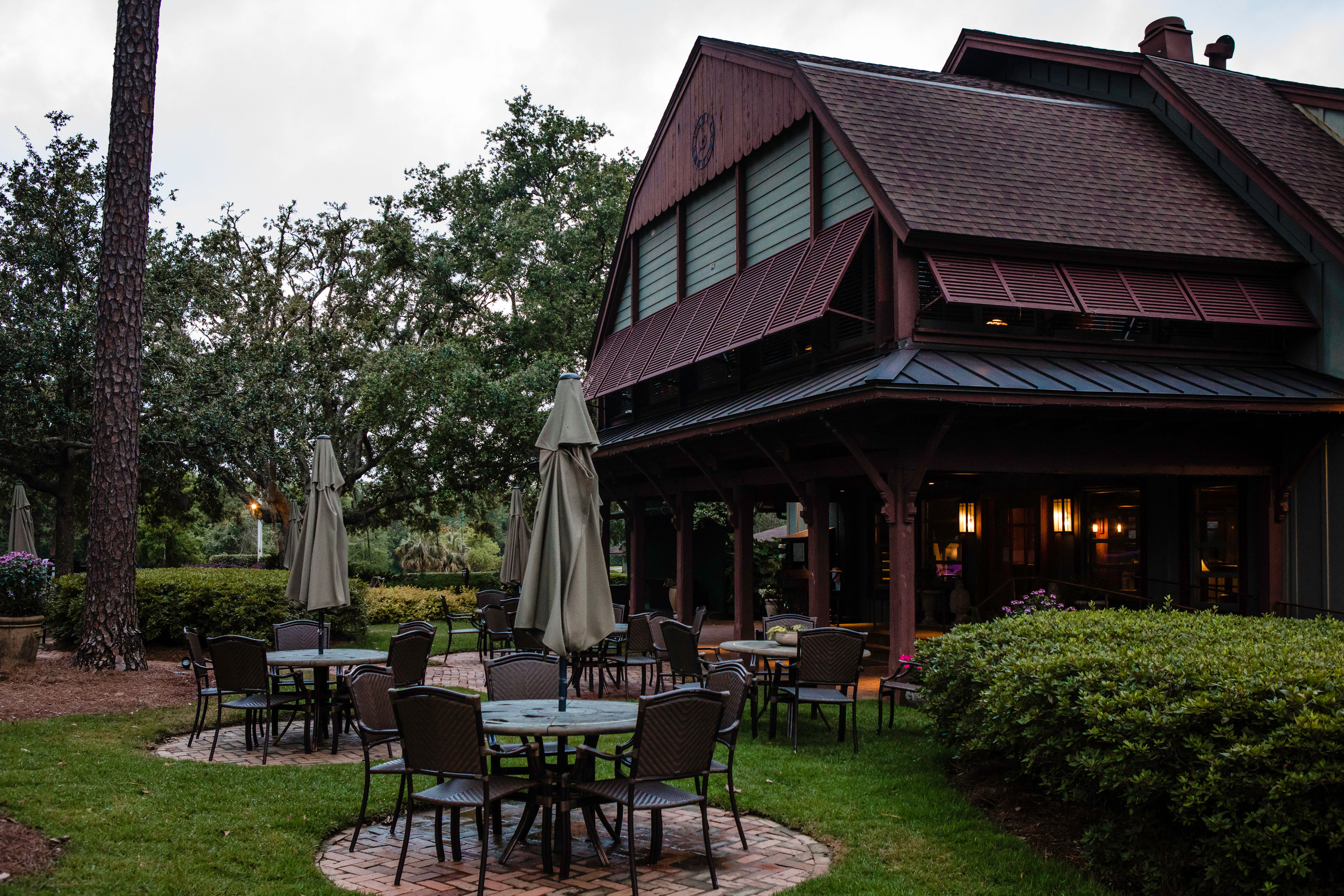 a patio area with tables and chairs outside of a building